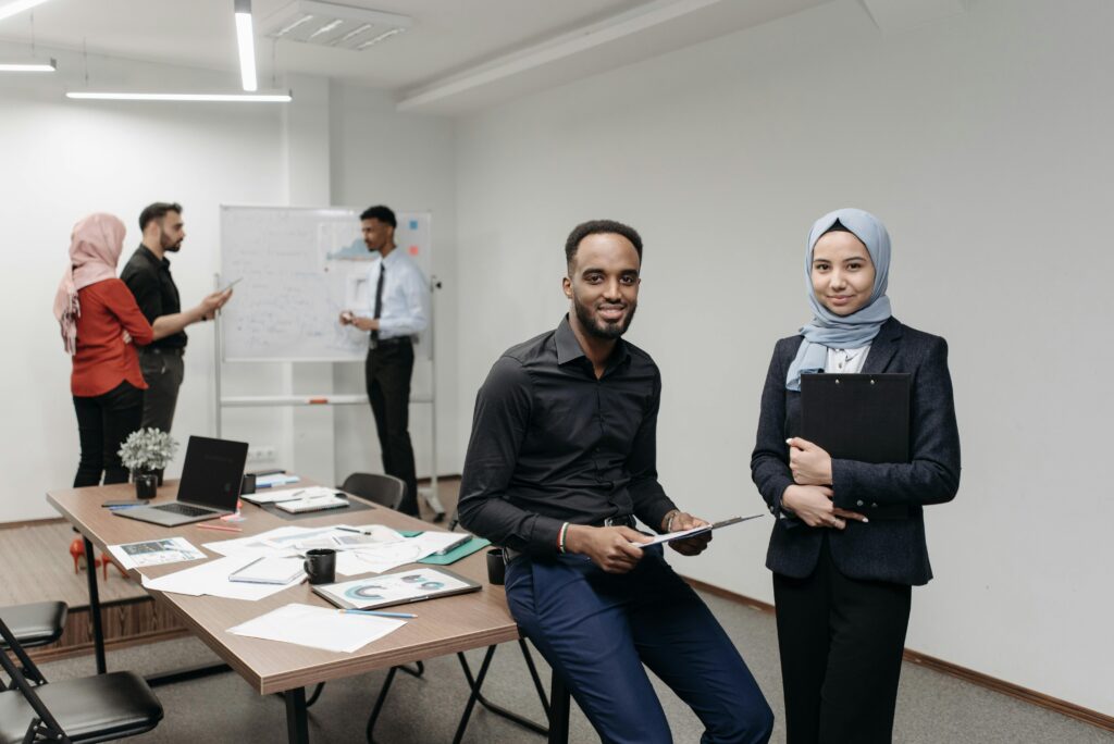 A diverse group of professionals working together in a modern office, focusing on teamwork and collaboration.